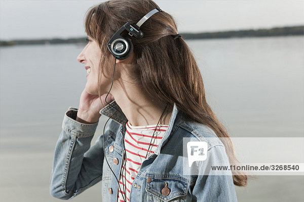 Lake Wannsee  Woman wearing headphones  smiling  portrait  close-up