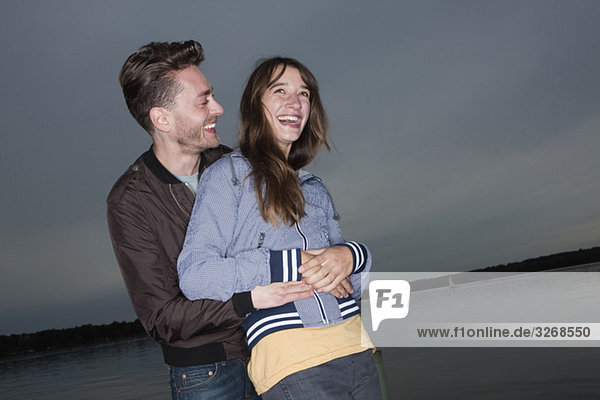 Germany  Berlin  Lake Wannsee  Young couple laughing  portrait