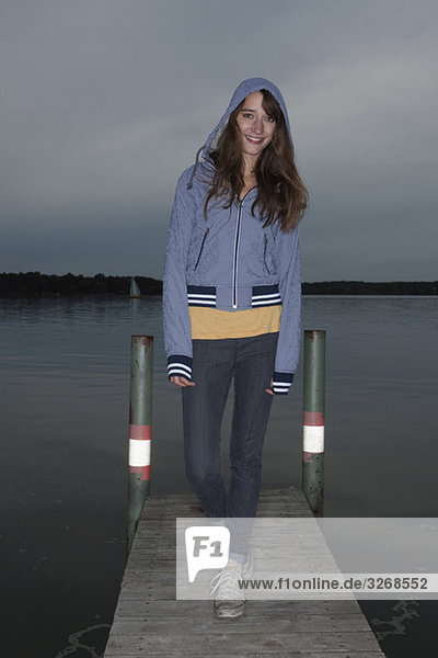 Lake Wannsee  Young woman standing on jetty  smiling  portrait