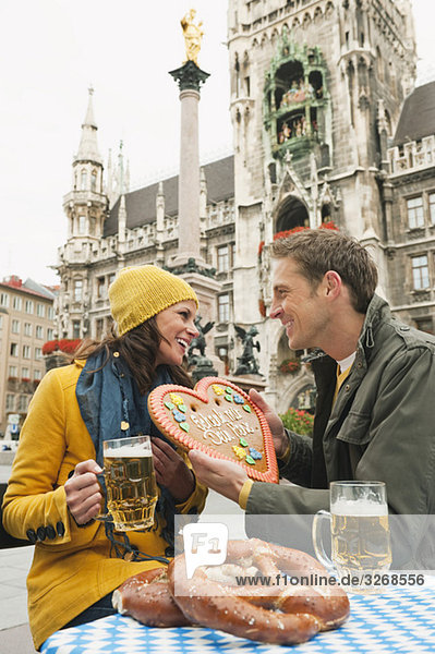 Marienplatz  Couple  man holding gingerbread heart  portrait