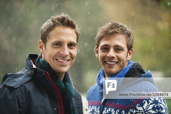 English Garden  Two men standing side by side  smiling  portrait  close-up