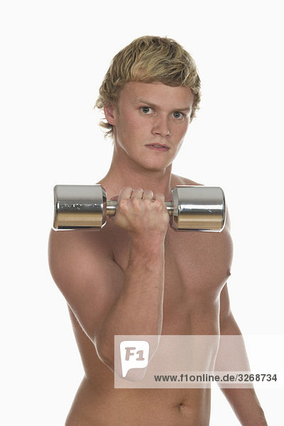 Young man exercising with a dumbbell  portrait  close-up