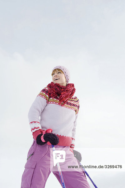 Italy South Tyrol Seiseralm Woman holding ski poles smiling portrait