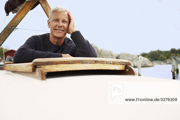 Middle aged man on old boat