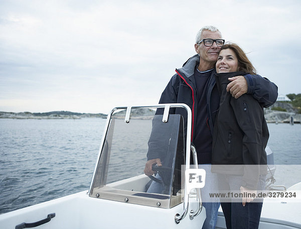Middle aged couple on motor boat