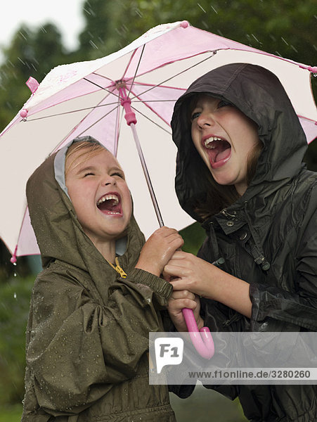 Mädchen unter einem Regenschirm singen