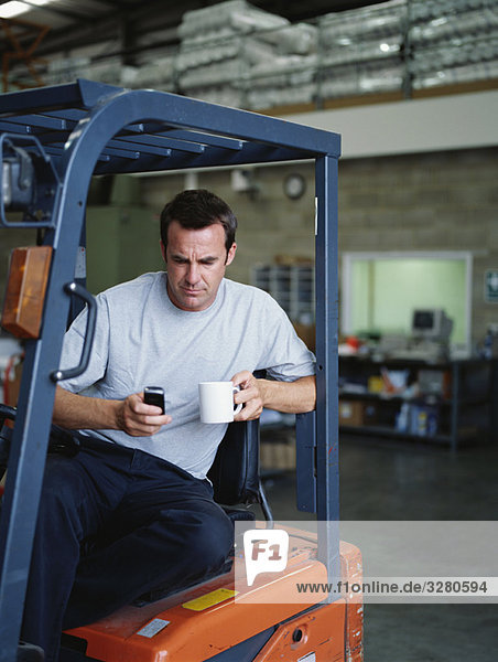 A warehouse manager takes a tea break