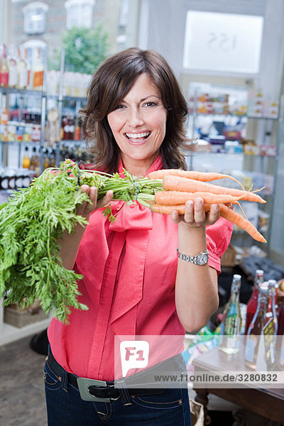 Woman in store with carrots
