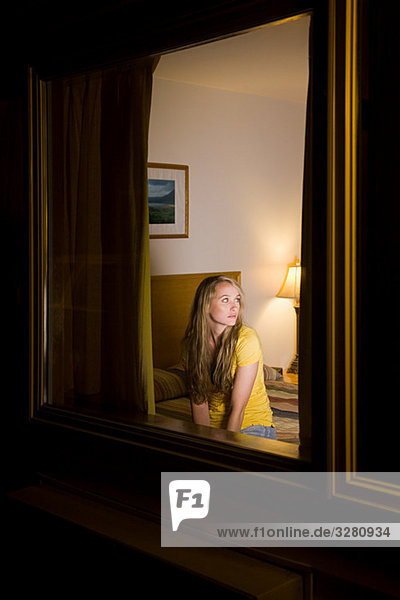 Young woman in motel room