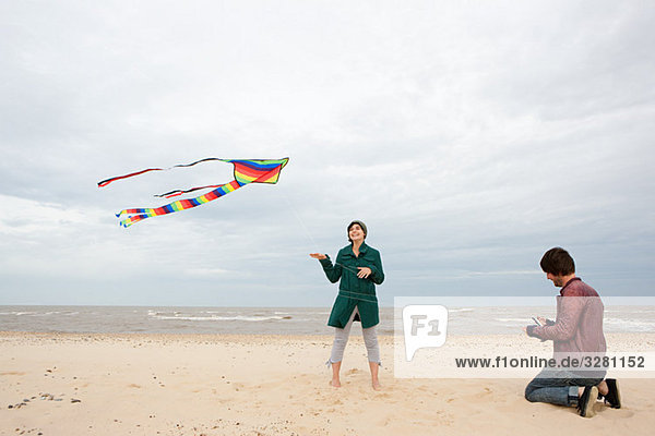 Couple on a beach with kite