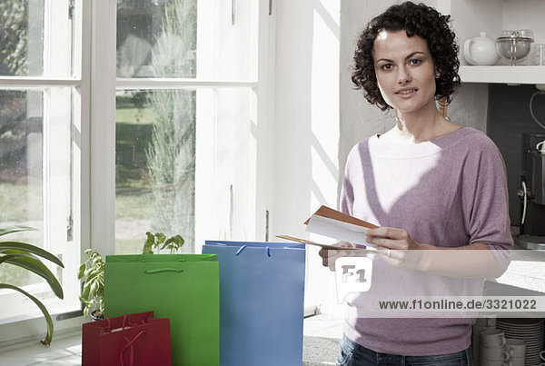 A woman standing with gift bags and cards