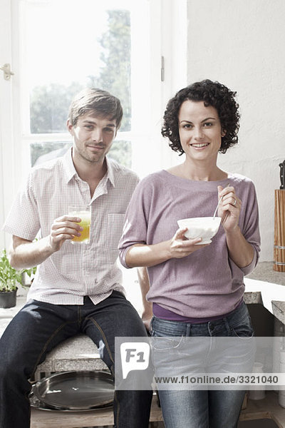 A couple having breakfast in the kitchen