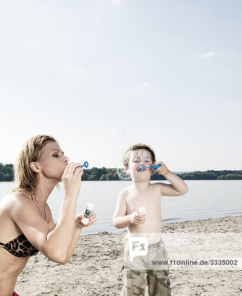 Mother and child blow bubbles
