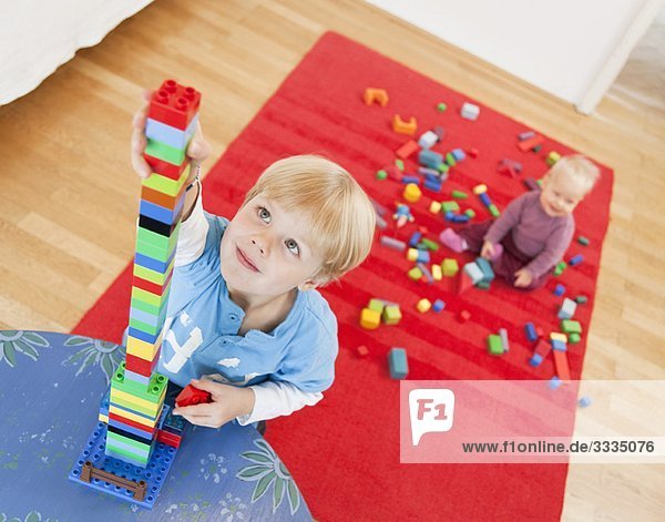 boy and baby with toy building blocks