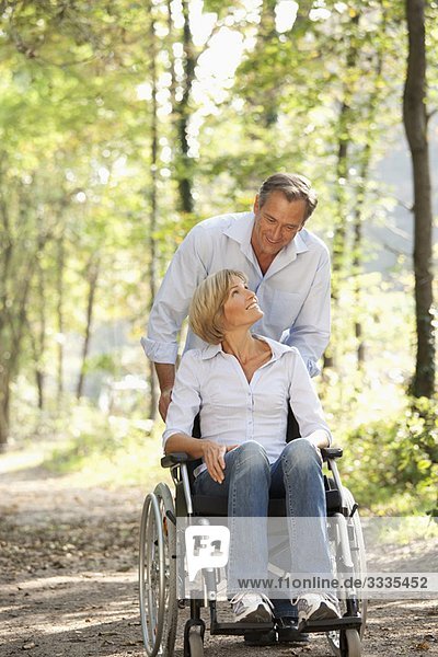 Man pushes woman in a wheelchair