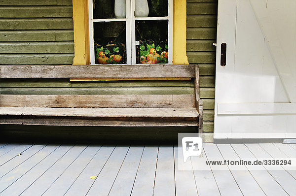 Holzbank auf Veranda mit Tür weiß und gelb Fensterrahmen  Drummondville  Québec