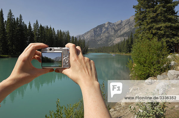 Tourist taking photograph in Banff National Park  Alberta