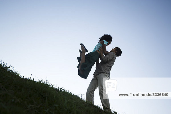 Young couple  woman jumping into man's arms