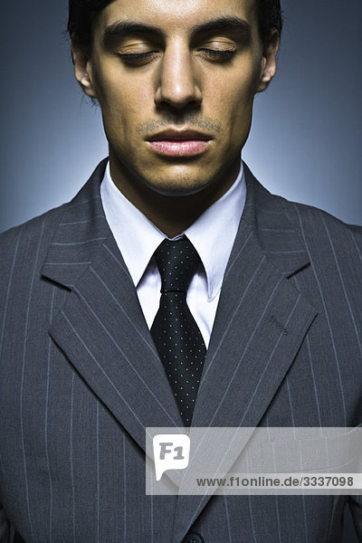 Businessman with eyes closed  portrait