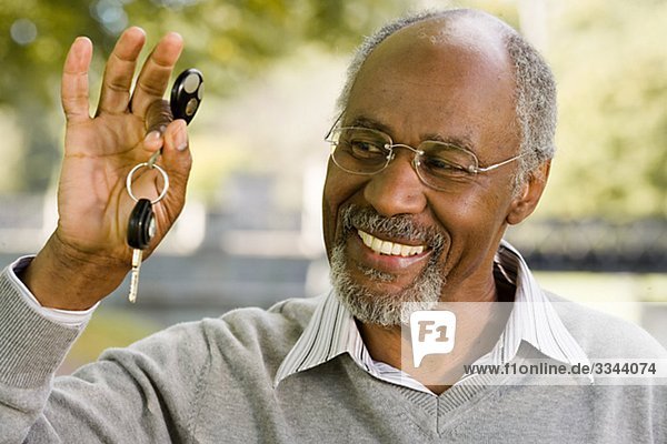 Senior man holding a car key  Sweden.