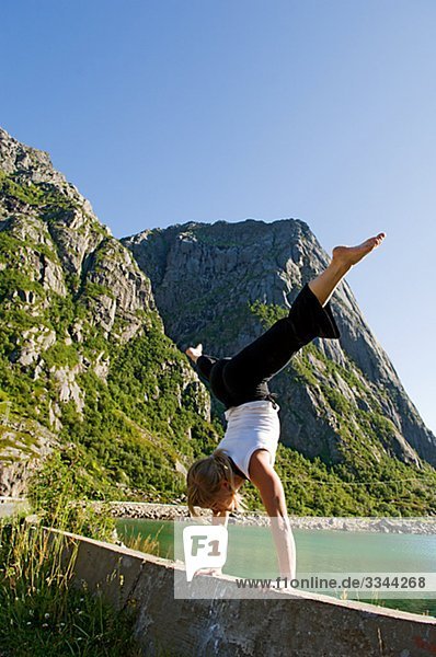 Woman doing a handstand  Norway.