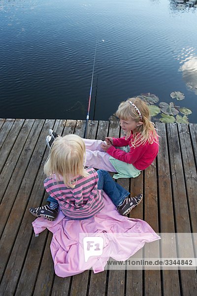 Girls angling for fish  Sweden.