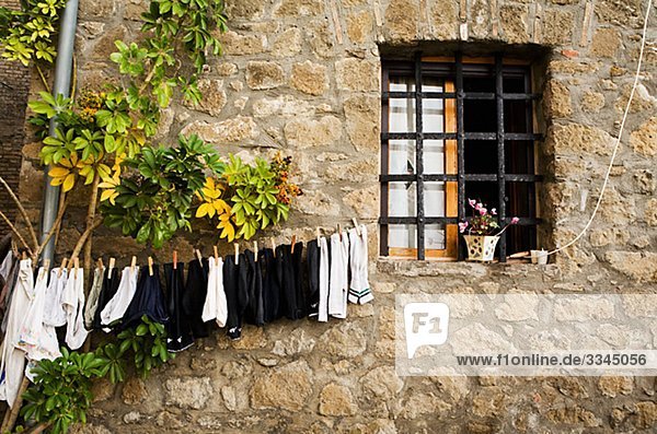 Clothes-line on a stone wall  Italy.