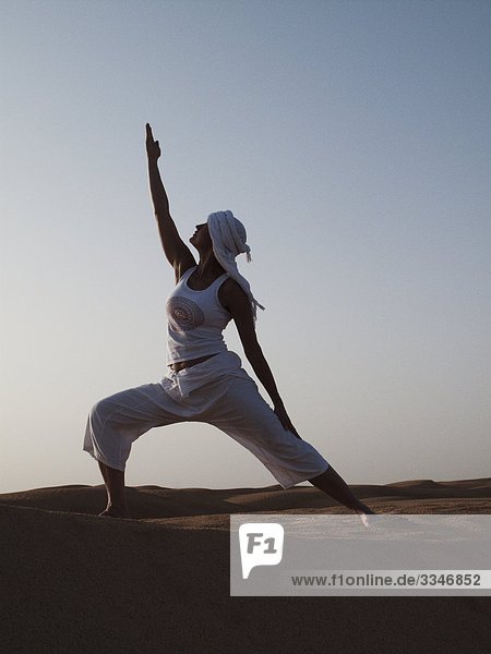 Woman performing yoga in the desert  Tunisia.