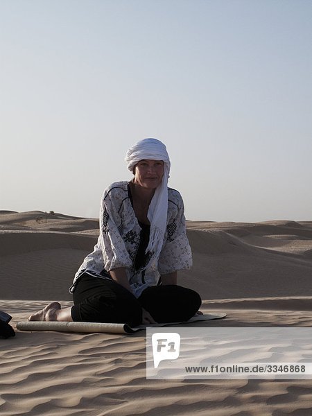 Woman relaxing in the desert  Tunisia.