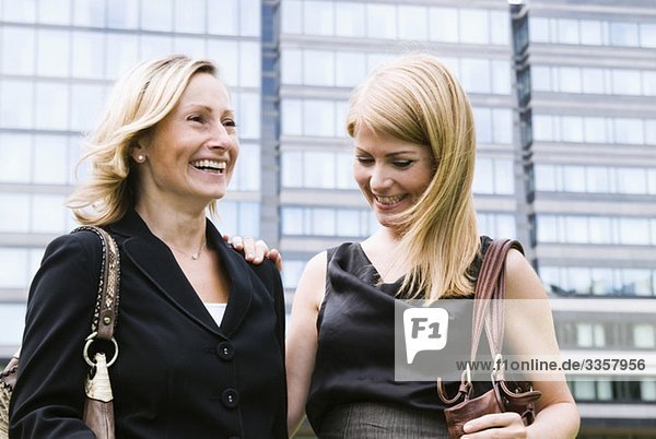 Two businesswomen walking outside