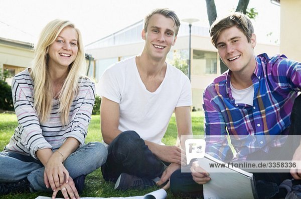 Three happy students outdoors