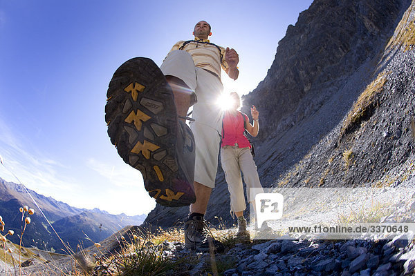 10874040  Switzerland  swiss  walk  hike  pair  couple  scenery  two  Davos  foot  frog perspective  dynamic  back light  mountains  scenery Davos  canton Graubunden  Grisons  Bundnerland  nature  footpath  persons  Strelapass
