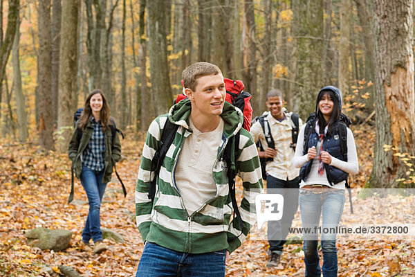 Young people hiking through forest