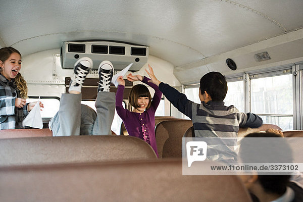 Children having fun on school bus
