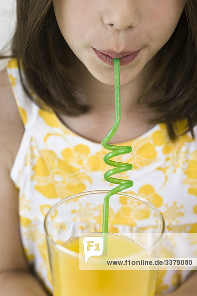 Drinking juice through curly straw