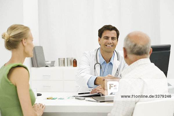 Doctor with senior patient providing medical consultation
