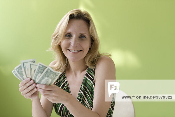 Woman holding handful of cash