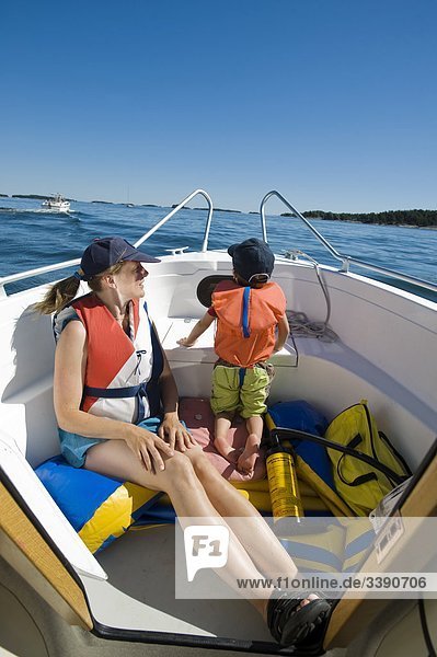 Woman and child in a motorboat  Sweden.