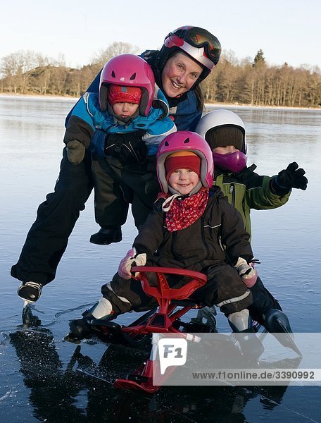 Portrait of a mother with her children on the ice  Sweden.