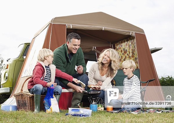 Family cooking together outdoors