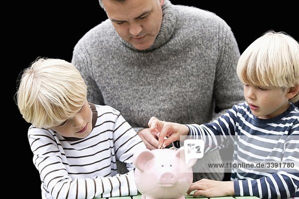 Father teaching sons to save