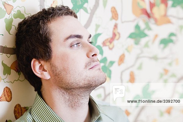 man leaning back of head against wall