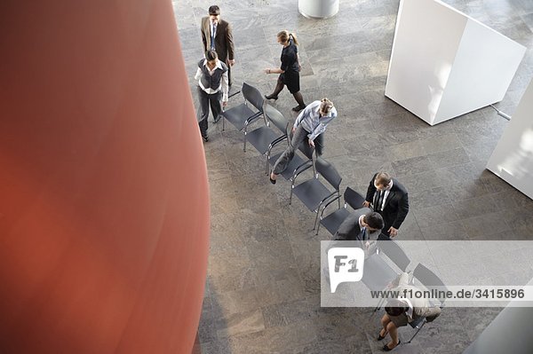 Gruppe von Geschäftsleuten mit Stühlen