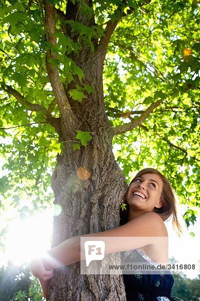 Girl hugging a tree