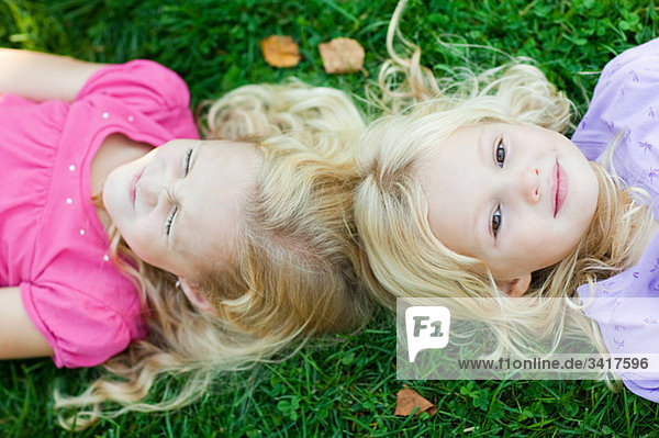 Girls lying on grass