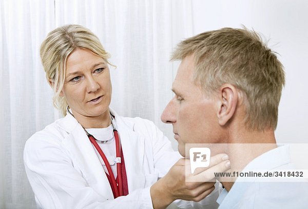 Doctor touching throat