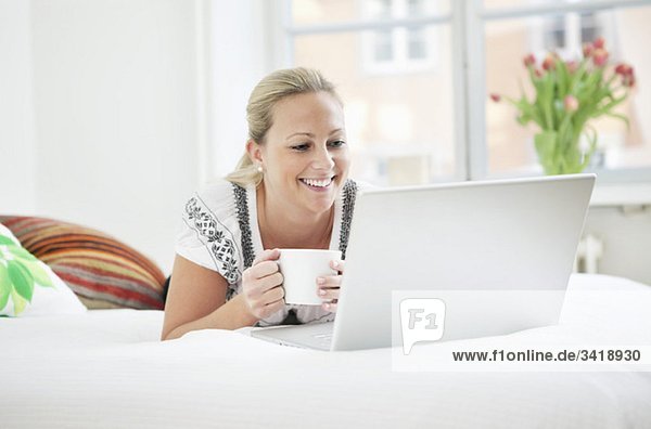 Woman with computer and coffee