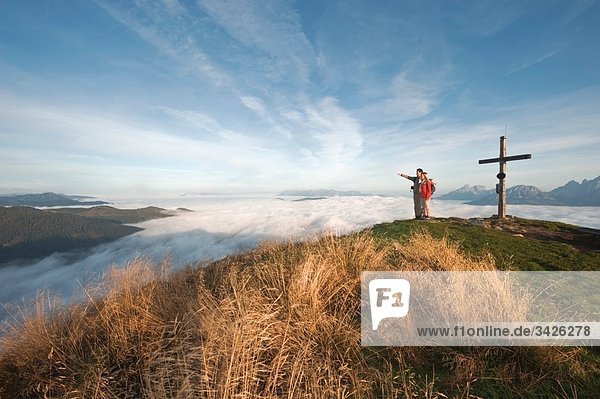 Austria  Steiermark  Reiteralm  Hikers in mountains  man pointing