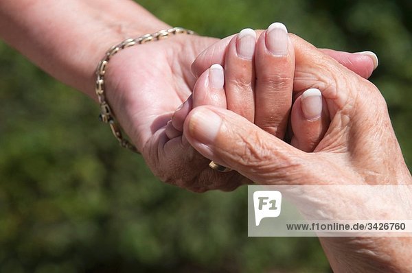 Senior women holding hands  close-up