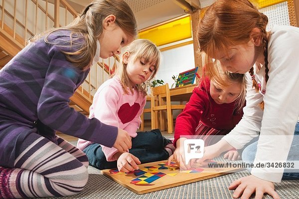 Germany  Children in nursery playing a learning game together  close-up